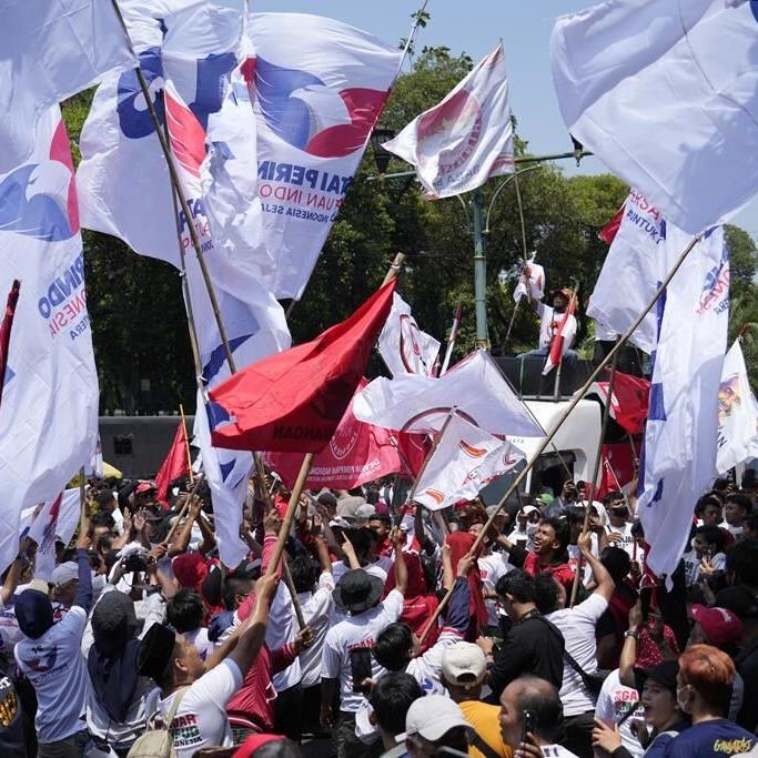 Indonesian presidential candidates register for next year's elections as supporters cheer